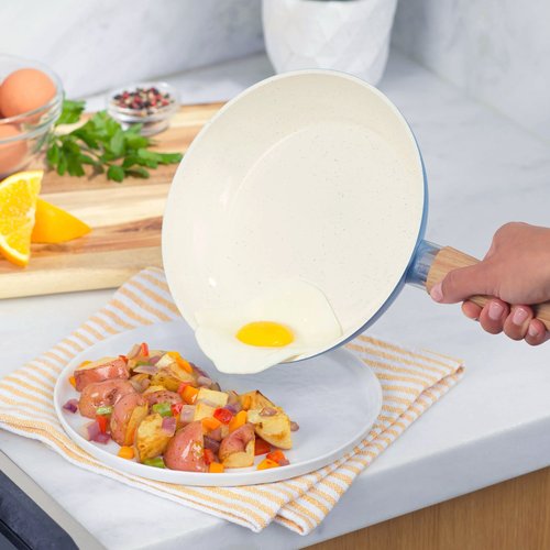 Nonstick Ceramic Cookware with hand holding pan egg sliding off